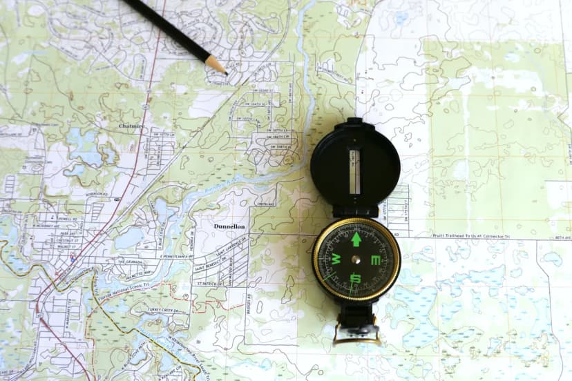 A detailed topographic map of Dunnellon, Florida with a compass and pencil.