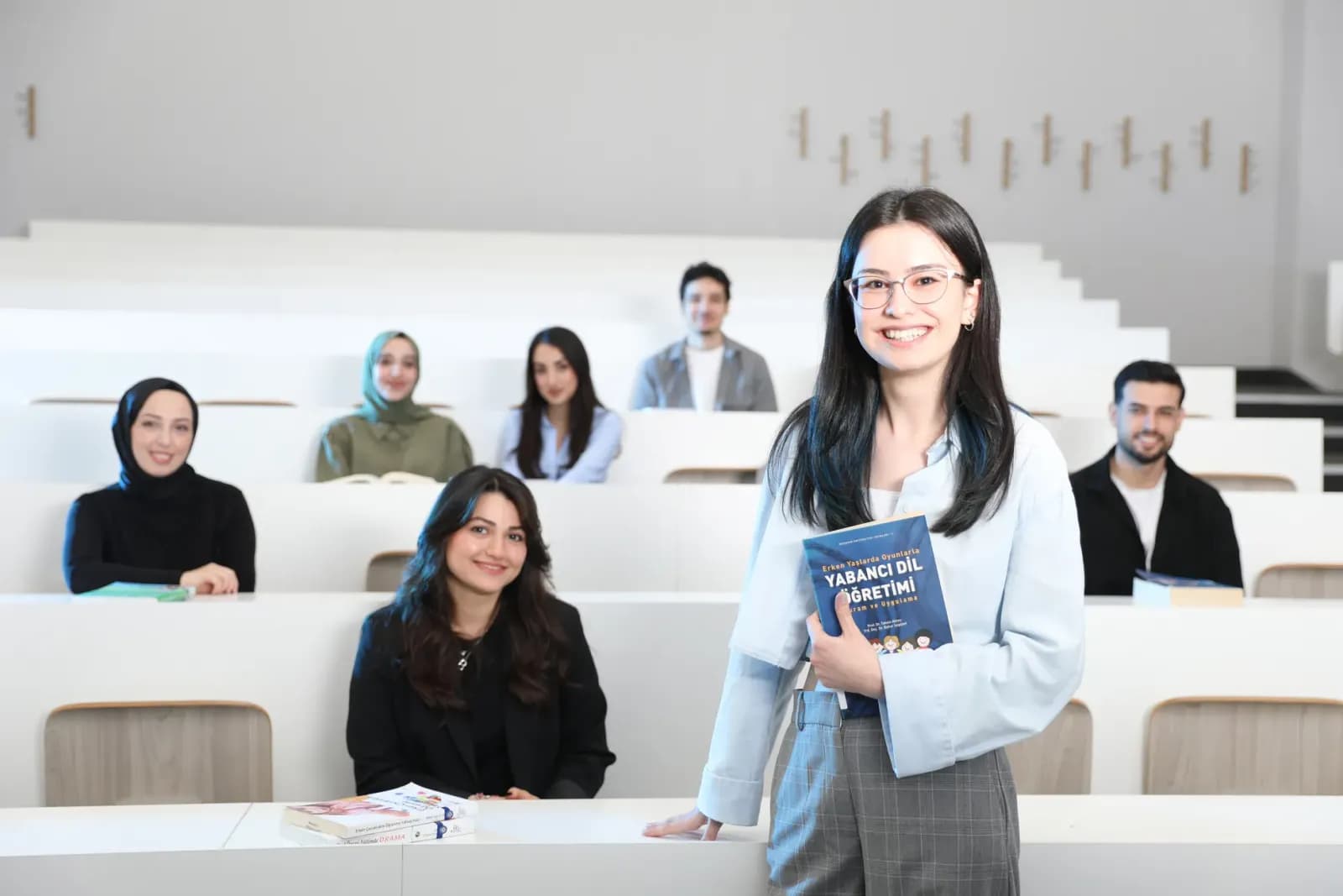 Group of diverse university students in a bright lecture hall, studying language education.