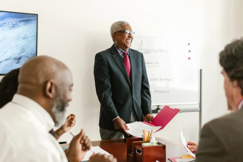 Professional meeting scene showcasing discussions and presentations in an office setting.