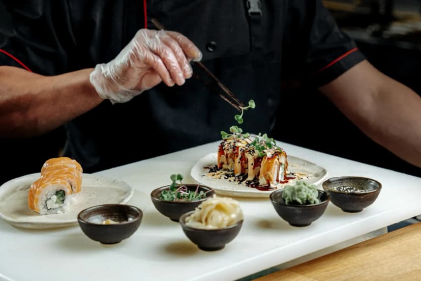 Chef crafting sushi with precision, showcasing gourmet elegance in a modern restaurant setting.