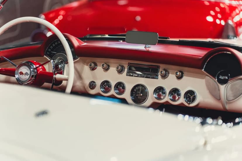 Close-up of a vintage car dashboard with retro design and classic details.
