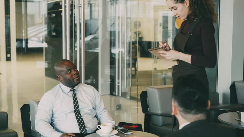 Professionals having a business meeting in a stylish coffee shop environment.