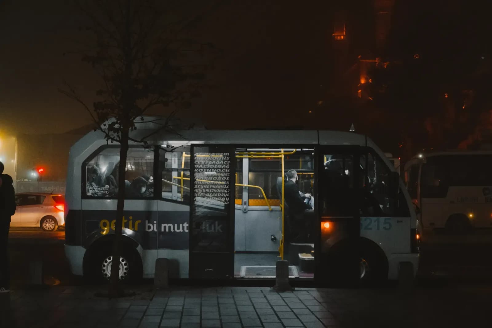 A public bus captured at night on a street in İstanbul, Türkiye.