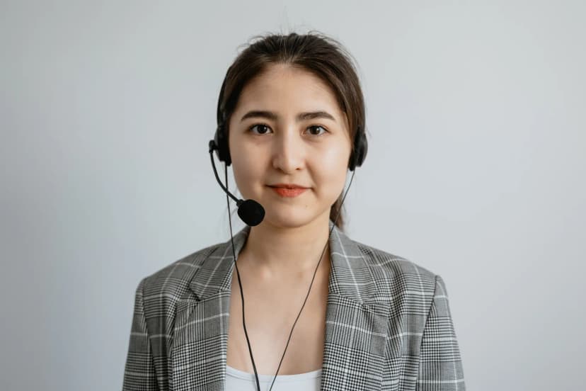 Portrait of a young female call center agent in a professional setting wearing a headset.