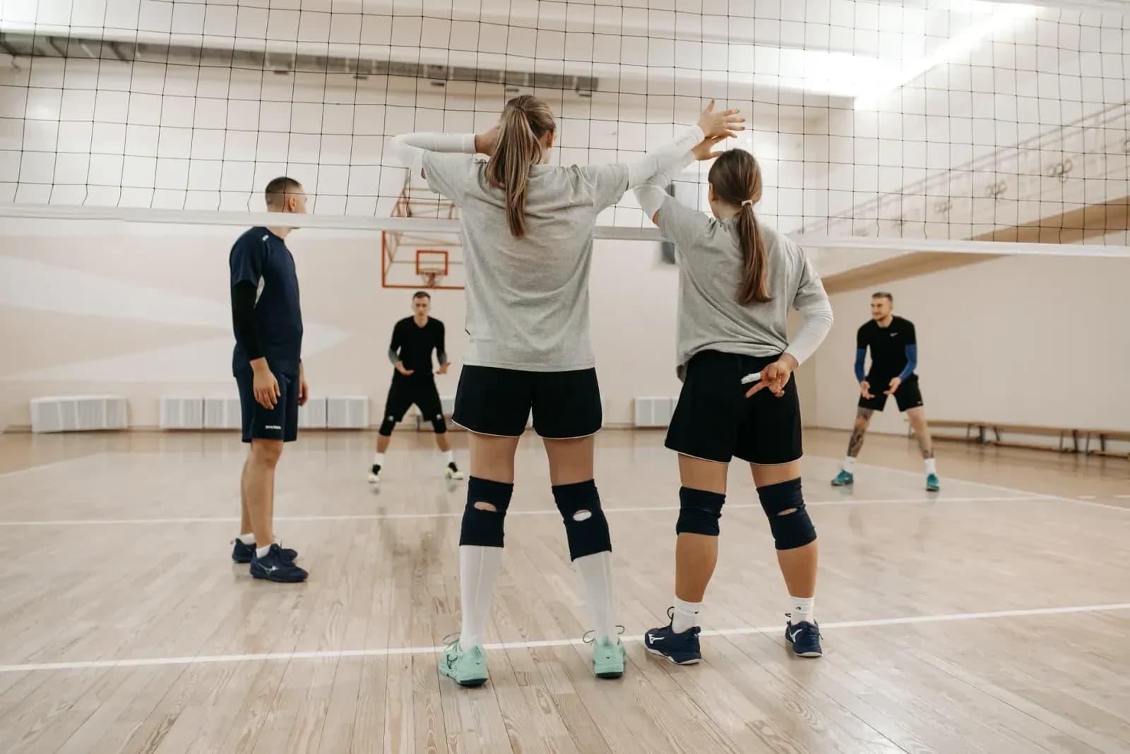 Voleybol antrenörü saha kenarında taktik tahtası ile çalışırken