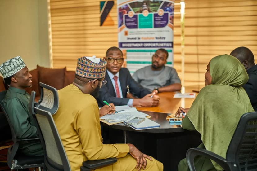 Professionals engaged in a business meeting in Kaduna, Nigeria discussing investment opportunities.